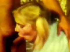 A young blond girl is laying on a bed with her tits bare. She is talking to a guy. A little later this babe is sucking his shlong whilst another dude is fucking her at the same time. The this babe gets a load of jizz in her face.